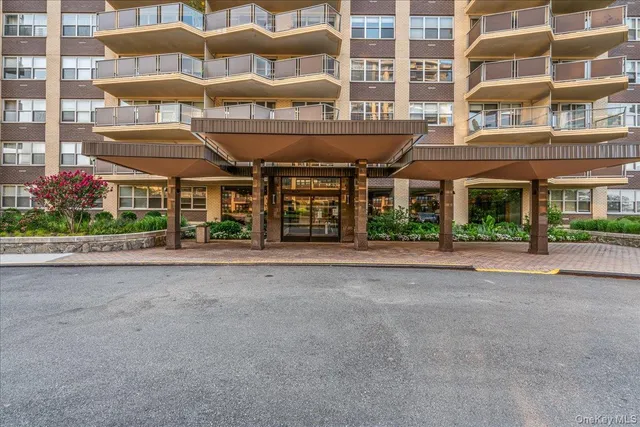 a front view of a building with a garden