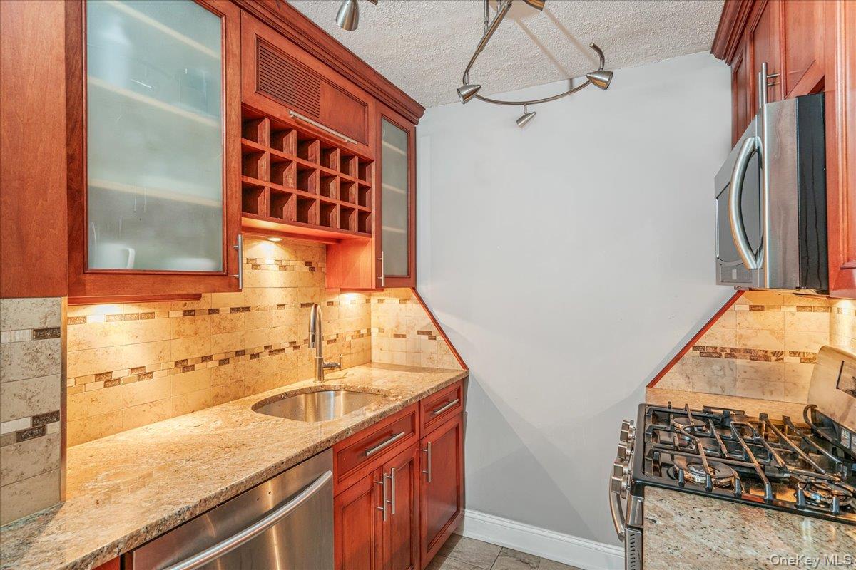 17-85 215th Street, Unit 9L Queens, NY 11360 - Photo 5 of 35 a bathroom with a granite countertop sink and a shower