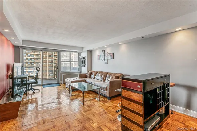 a living room with furniture and a floor to ceiling window