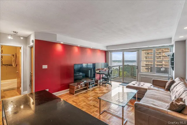 a living room with furniture and a floor to ceiling window