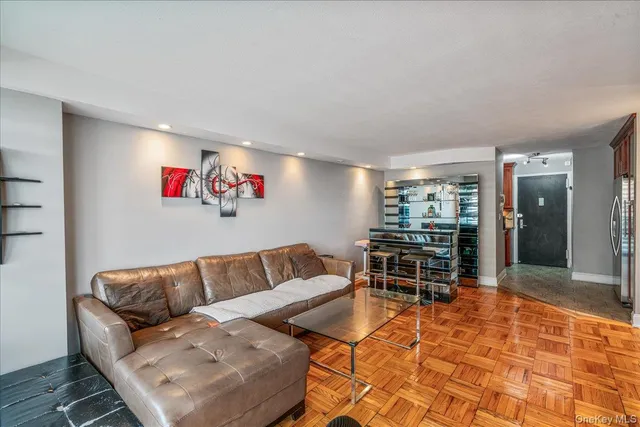 a living room with furniture a dining table and kitchen view