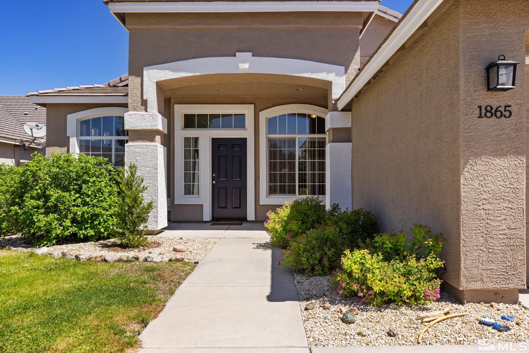 1865 Montelena Court Reno, NV 89521 - Photo 3 of 34 a front view of a house with a garden