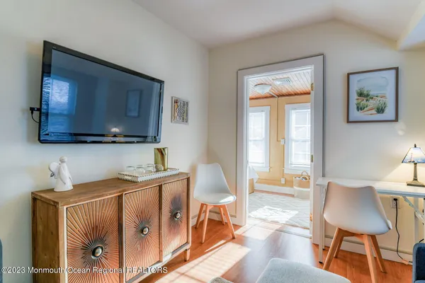 a bedroom with furniture and a flat screen tv