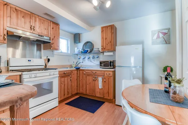 a kitchen with stainless steel appliances granite countertop a sink dishwasher stove and refrigerator