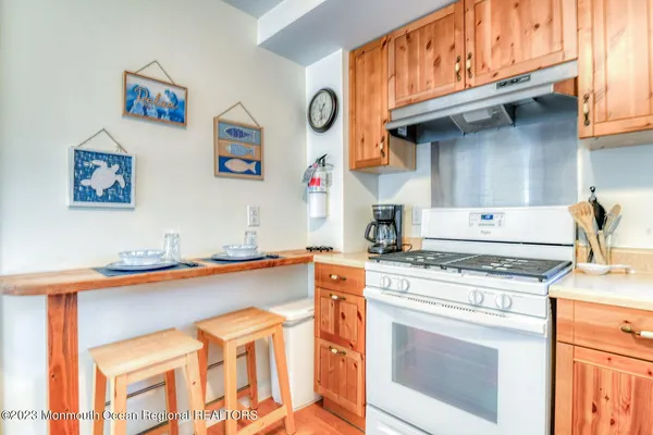 a kitchen with stainless steel appliances granite countertop a stove and a microwave