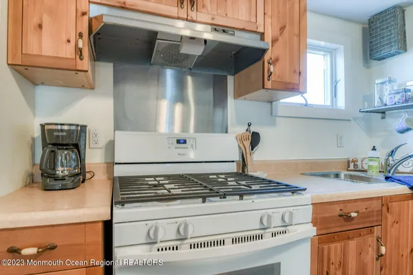 a stove top oven sitting inside of a kitchen