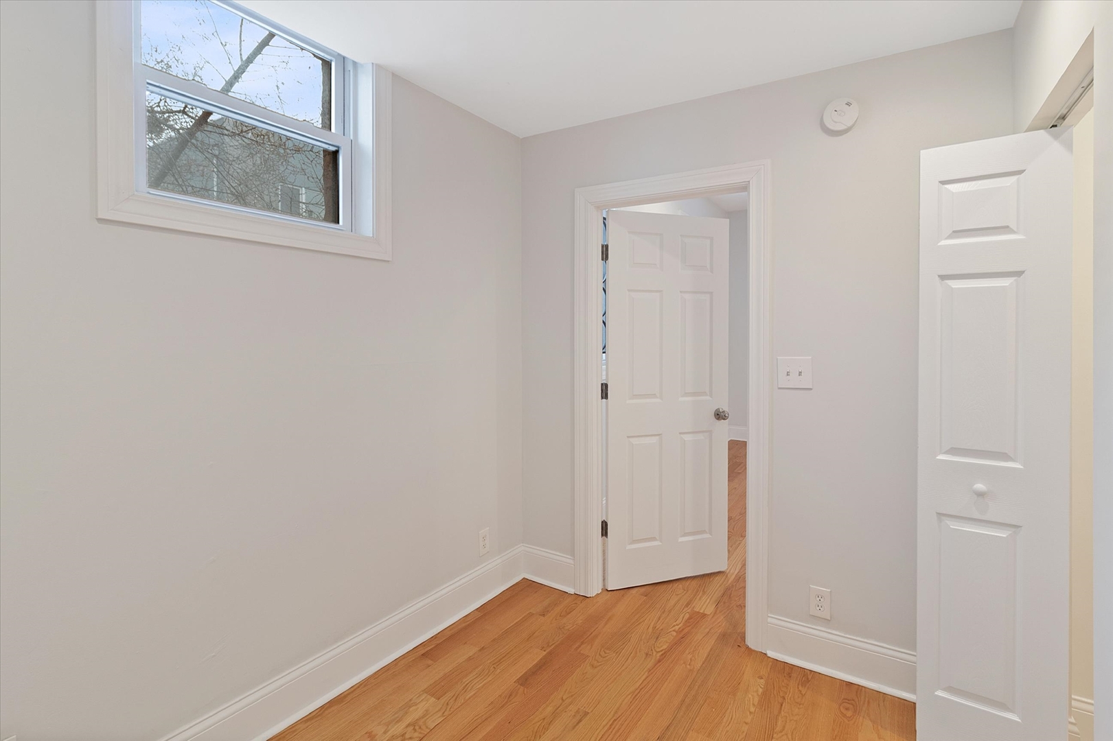 1729 South Halsted Street, Unit 2 Chicago, IL 60608 - Photo 11 of 14 an empty room with a door and wooden floor