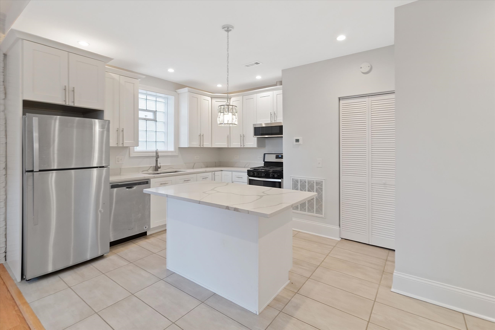 1729 South Halsted Street, Unit 2 Chicago, IL 60608 - Photo 2 of 14 a kitchen with stainless steel appliances granite countertop a refrigerator a sink and a stove