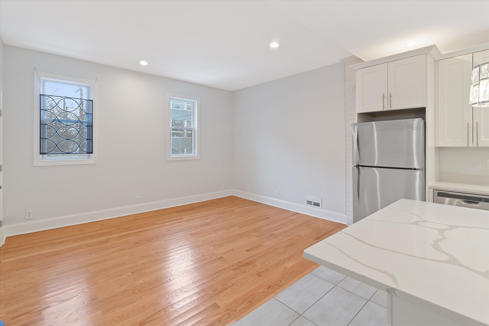 1729 South Halsted Street, Unit 2 Chicago, IL 60608 - Photo 3 of 14 a view of a bedroom with wooden floor and a refrigerator