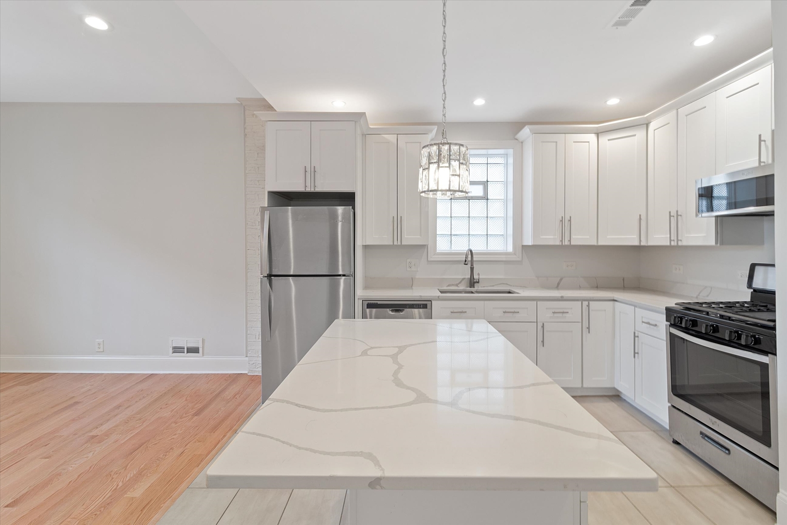 1729 South Halsted Street, Unit 2 Chicago, IL 60608 - Photo 4 of 14 a kitchen with stainless steel appliances granite countertop a sink a stove a refrigerator and cabinets