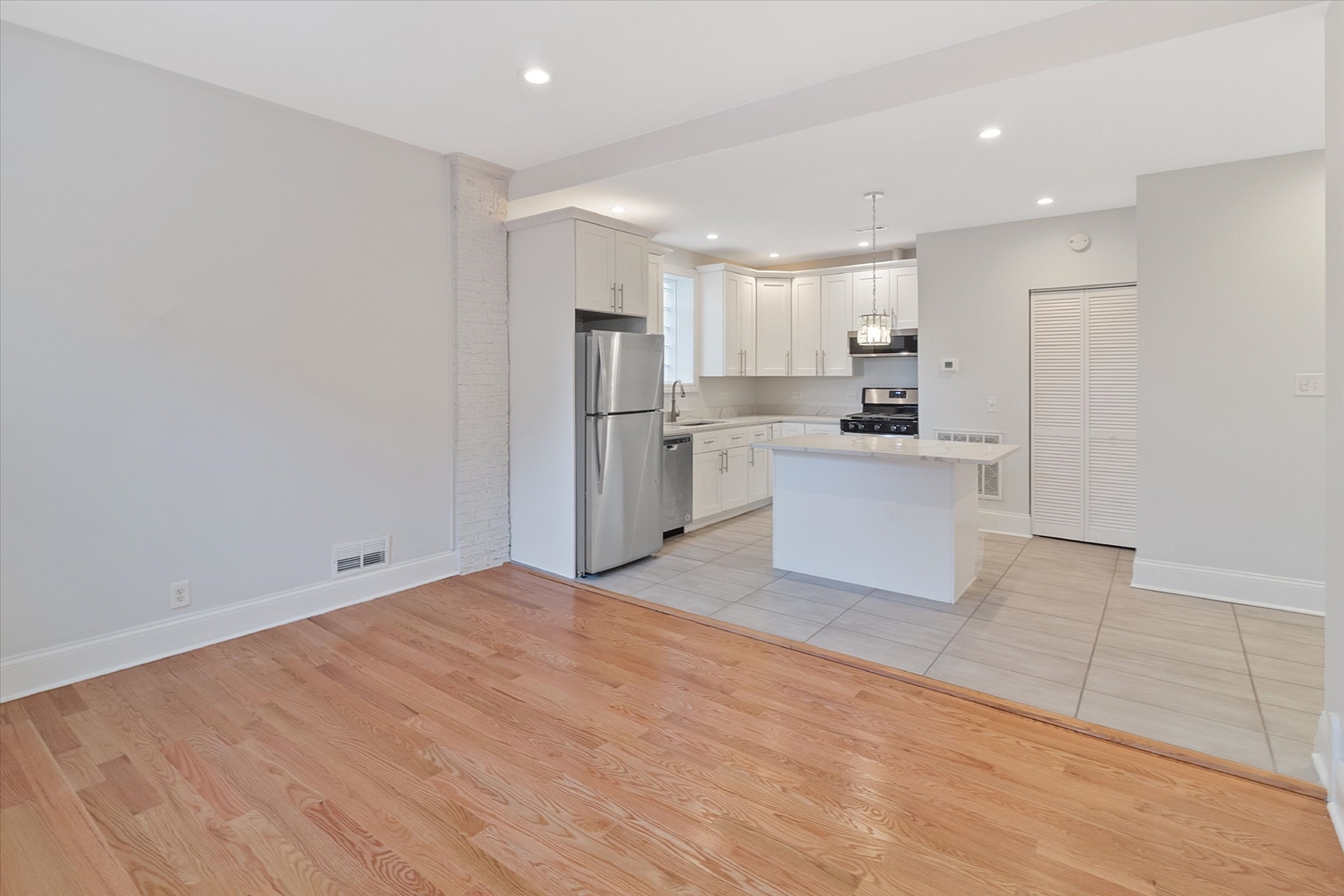 1729 South Halsted Street, Unit 2 Chicago, IL 60608 - Photo 6 of 14 a kitchen with stainless steel appliances a refrigerator sink and microwave