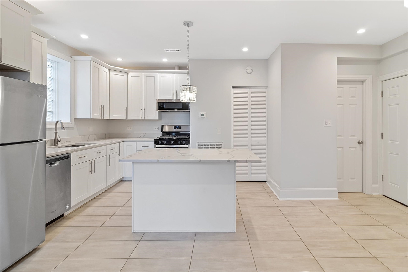 1729 South Halsted Street, Unit 2 Chicago, IL 60608 - Photo 7 of 14 a kitchen with white cabinets a sink and white appliances
