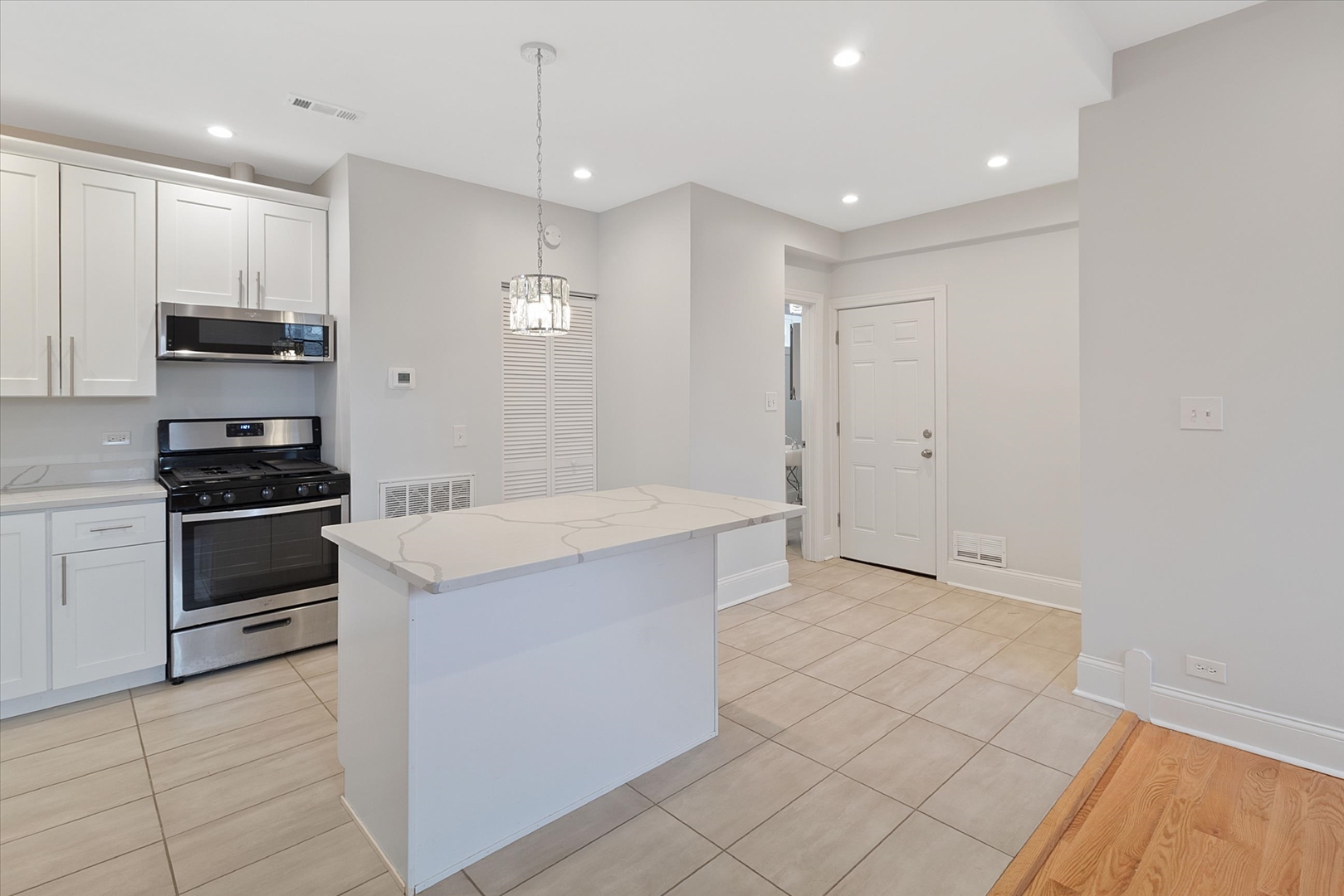 1729 South Halsted Street, Unit 2 Chicago, IL 60608 - Photo 8 of 14 a kitchen with stainless steel appliances a refrigerator and a stove top oven