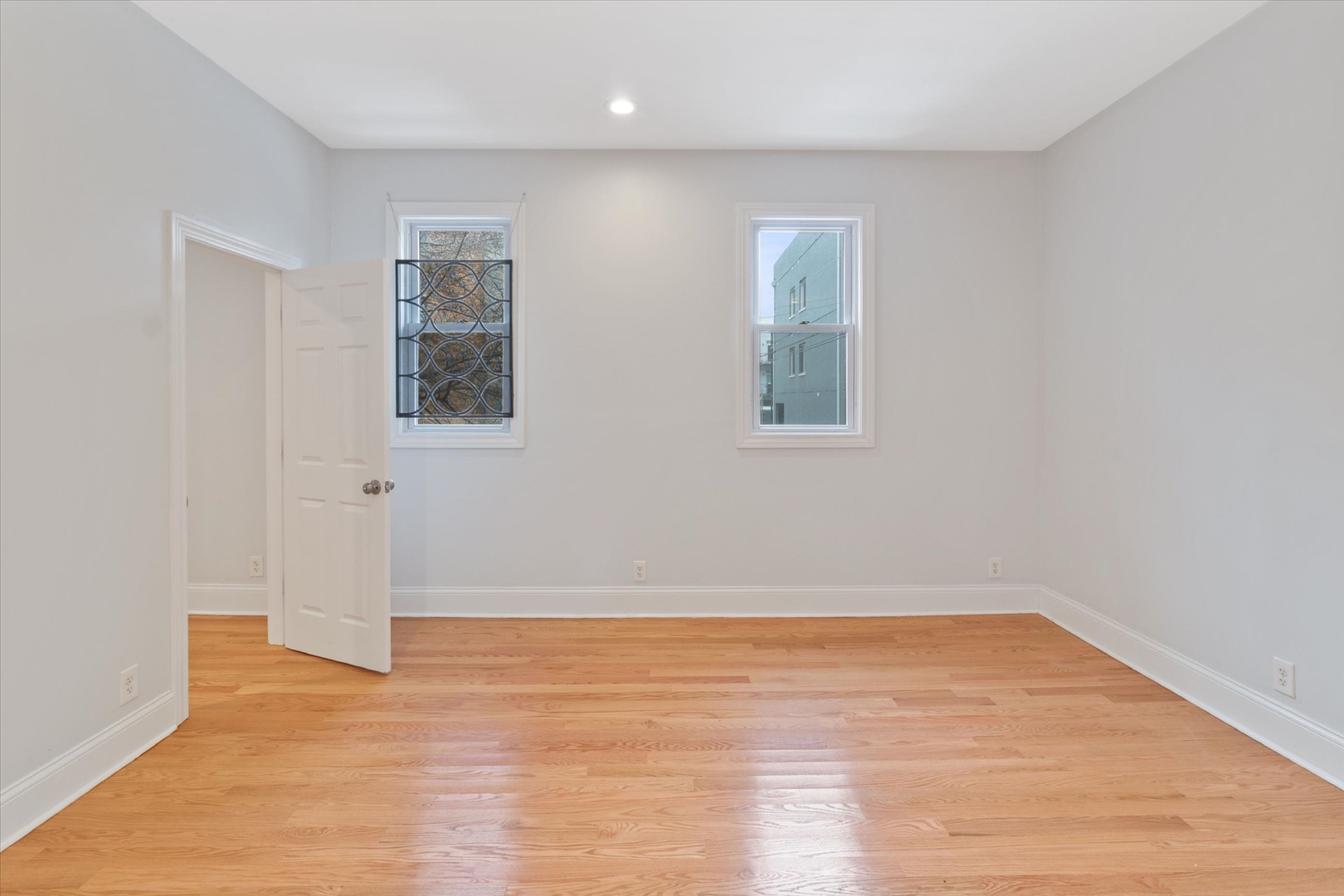 1729 South Halsted Street, Unit 2 Chicago, IL 60608 - Photo 9 of 14 an empty room with wooden floor and windows