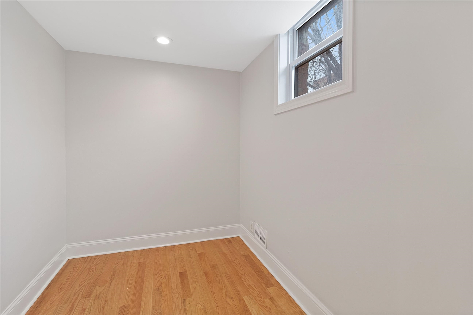 1729 South Halsted Street, Unit 2 Chicago, IL 60608 - Photo 10 of 14 a view of a small space with wooden floor and a window
