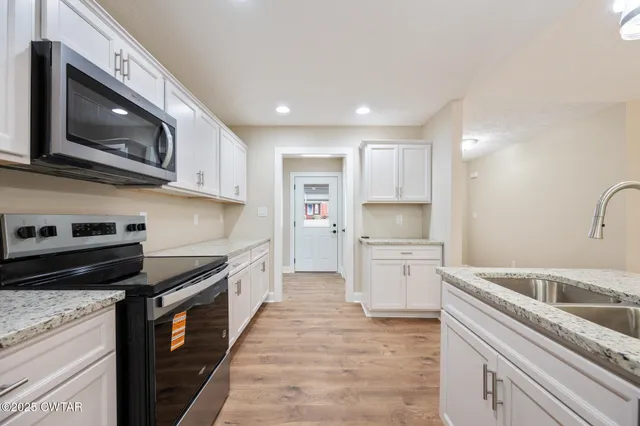 a kitchen with a stove microwave and sink