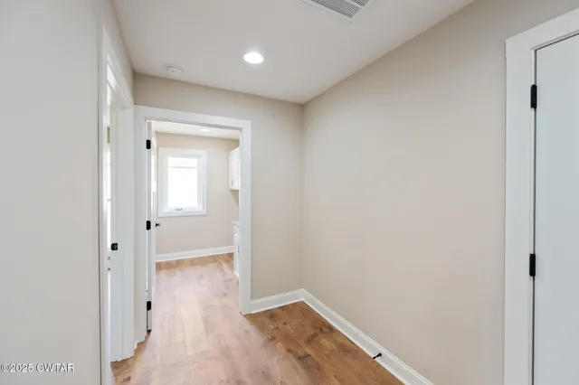 a view of a room with wooden floor