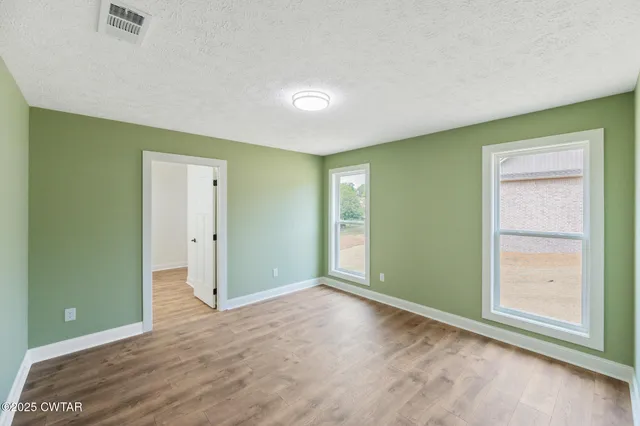 an empty room with closet area