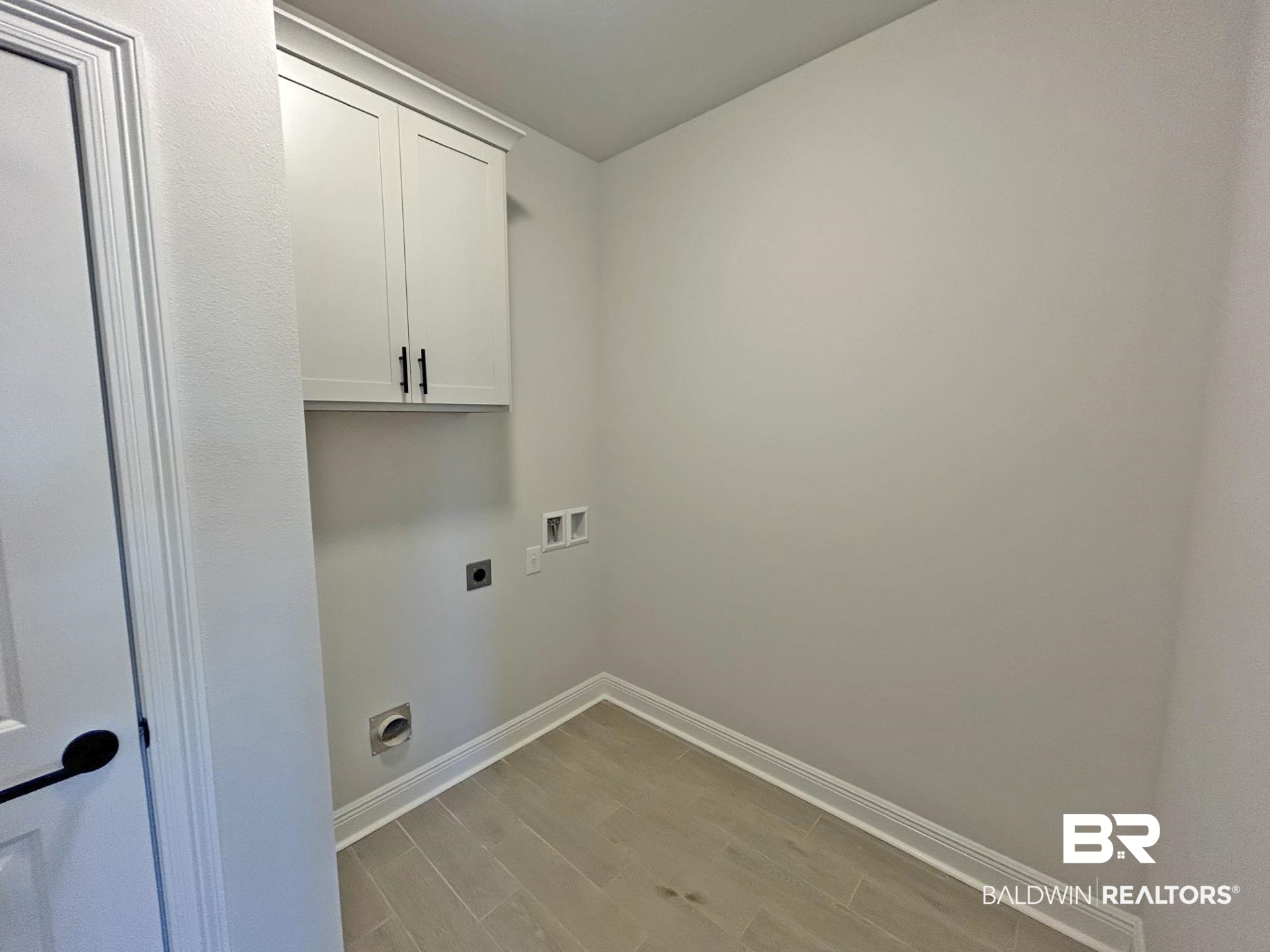 1748 Breckinridge Place Foley, AL 36535 - Photo 16 of 25 Laundry area with light wood-style flooring, electric dryer hookup, cabinet space, and washer hookup