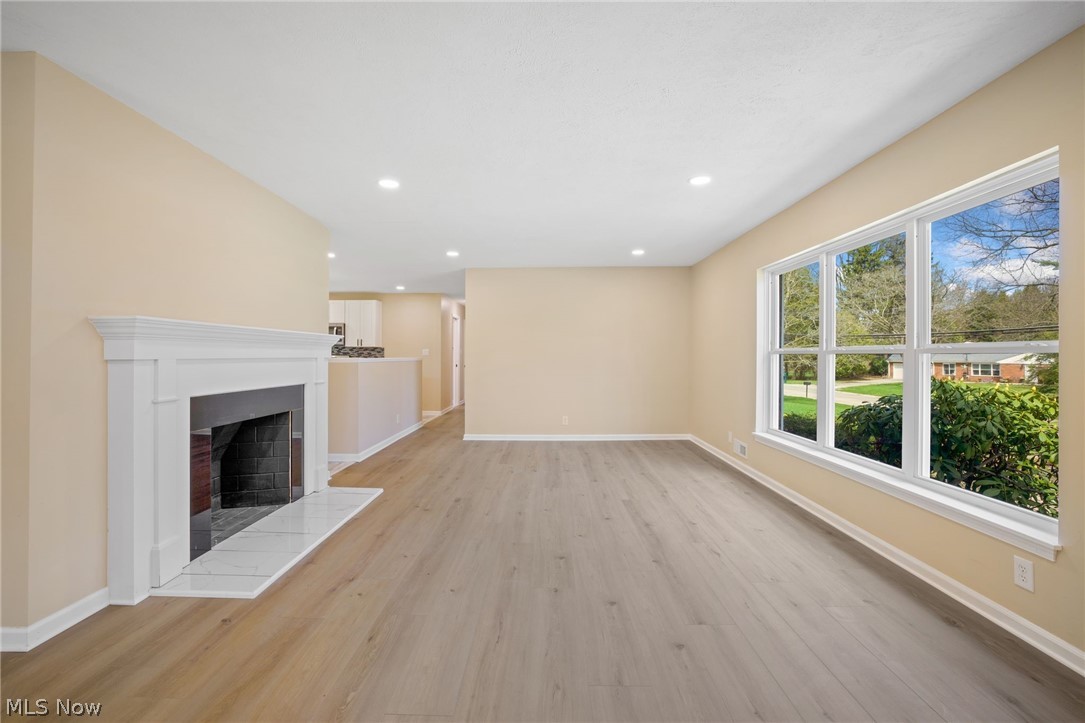 154 Winchester Road Akron, OH 44333 - Photo 6 of 26 Unfurnished living room with light hardwood / wood-style floors and a fireplace