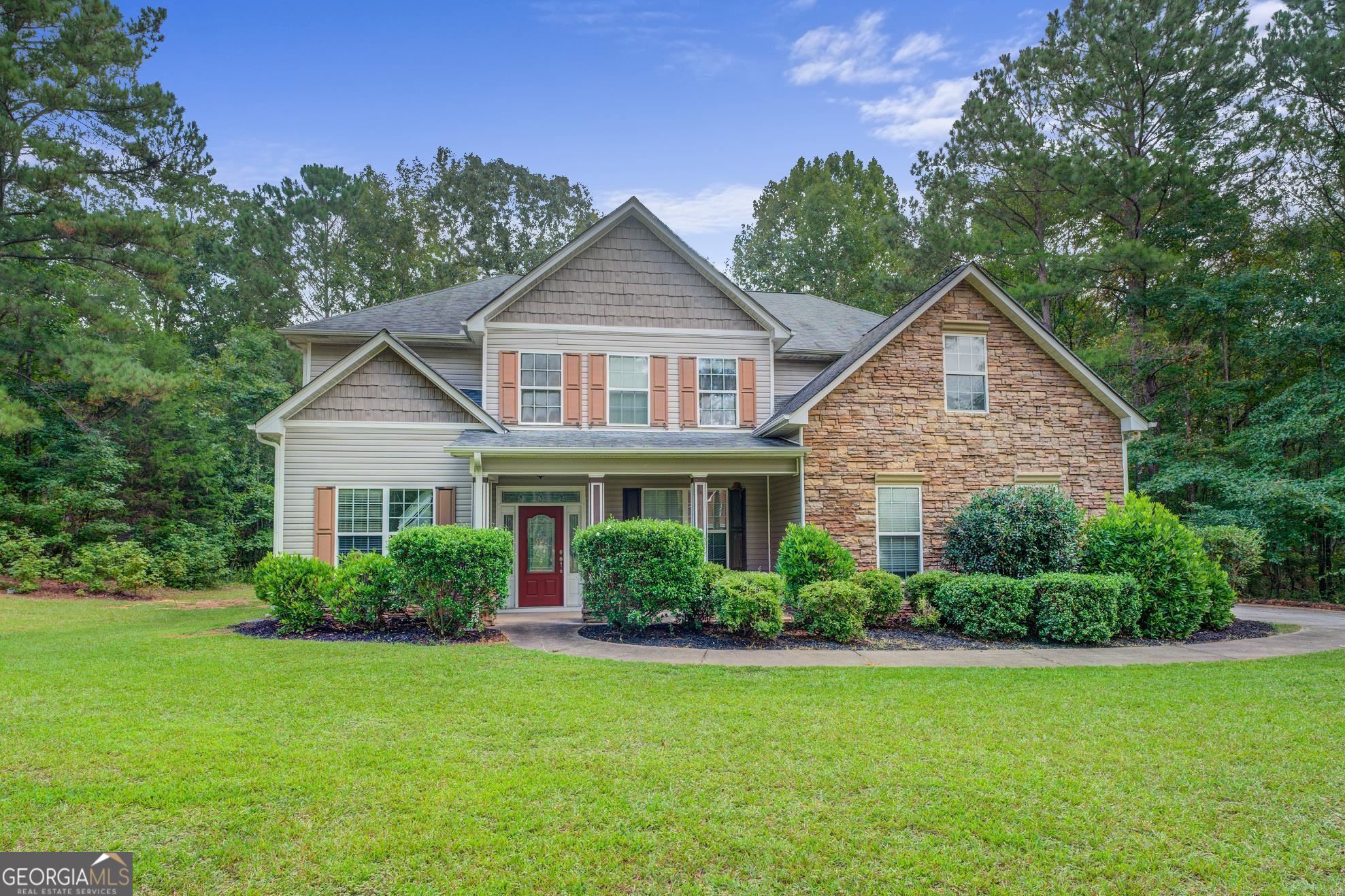 108 Liberty Trace Milner, GA 30257 - Photo 1 of 1 a front view of a house with a yard and potted plants