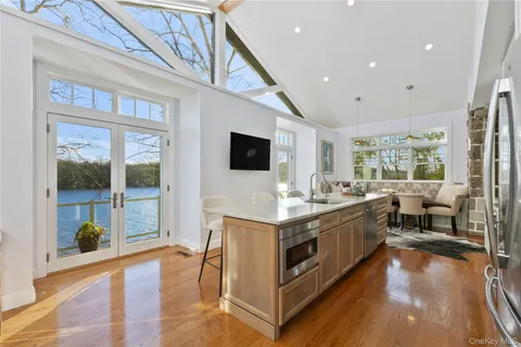 a view of living room filled with furniture and flat screen tv