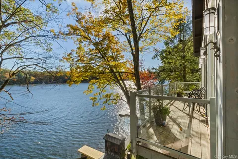 a kitchen with stainless steel appliances granite countertop a stove top oven a sink a dining table and chairs