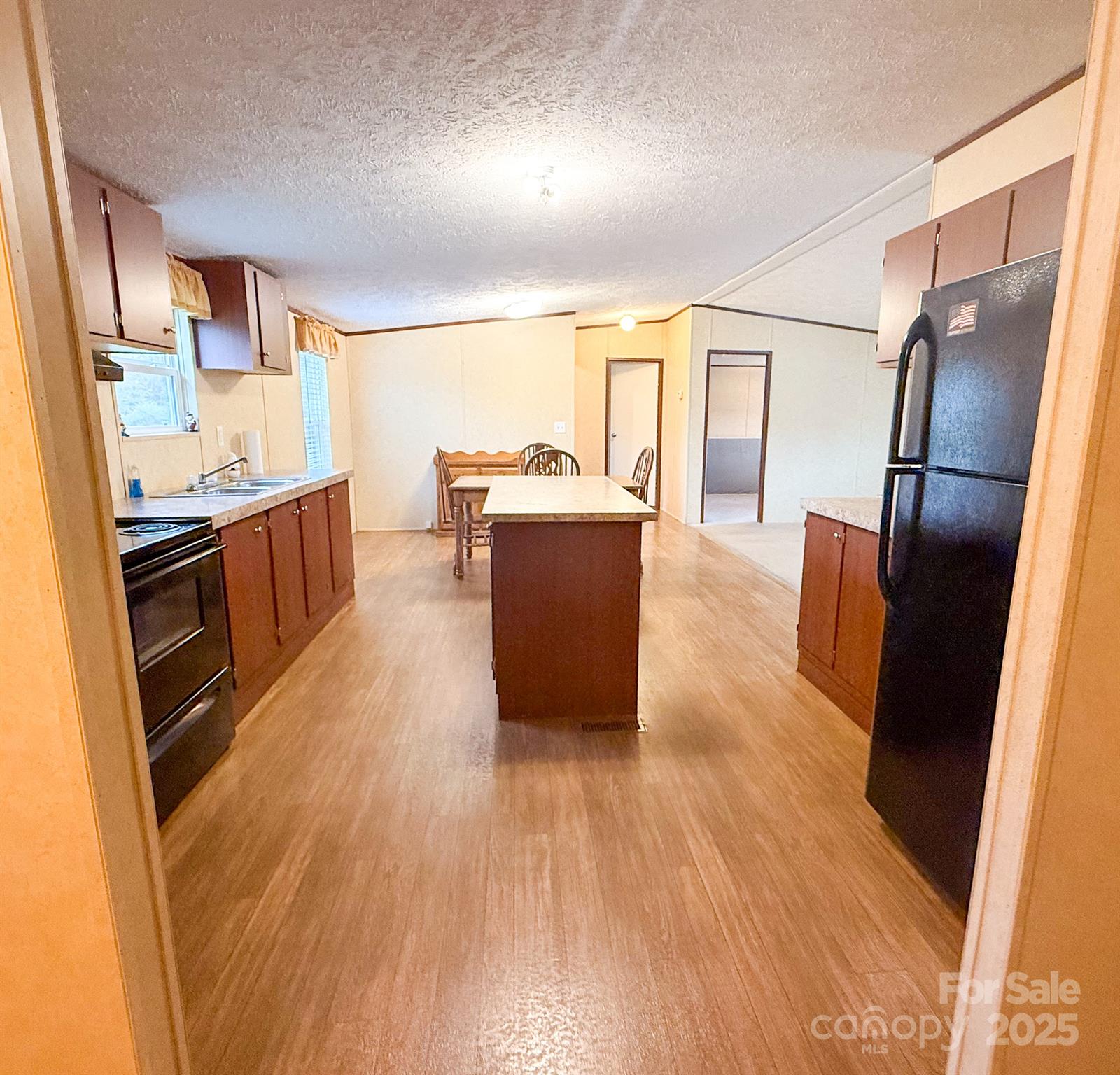 4559 Union Highway Gaffney, SC 29340 - Photo 12 of 23 a living room with stainless steel appliances wooden floor and a large window