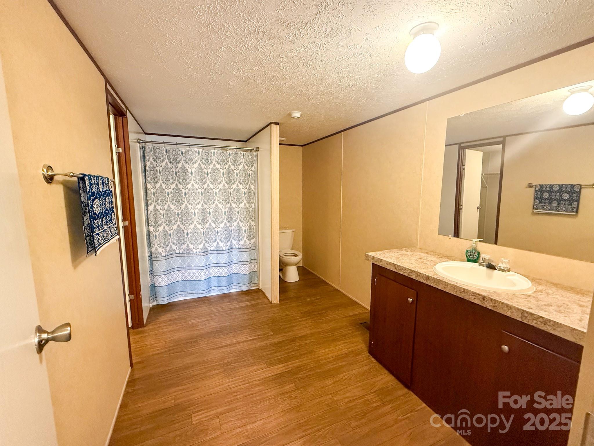 4559 Union Highway Gaffney, SC 29340 - Photo 15 of 23 a bathroom with a granite countertop sink a mirror and shower