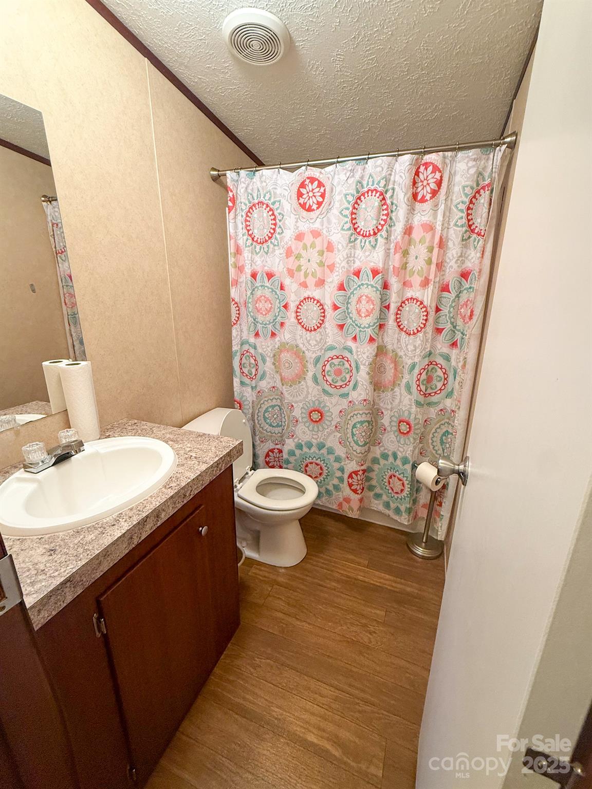 4559 Union Highway Gaffney, SC 29340 - Photo 19 of 23 a bathroom with a granite countertop sink a toilet and a shower curtain