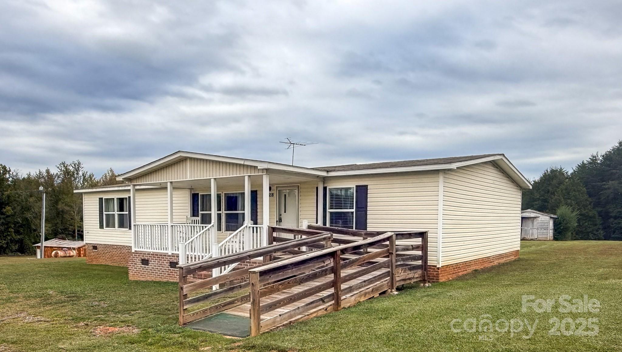 4559 Union Highway Gaffney, SC 29340 - Photo 2 of 23 a front view of a house with a yard table and chairs