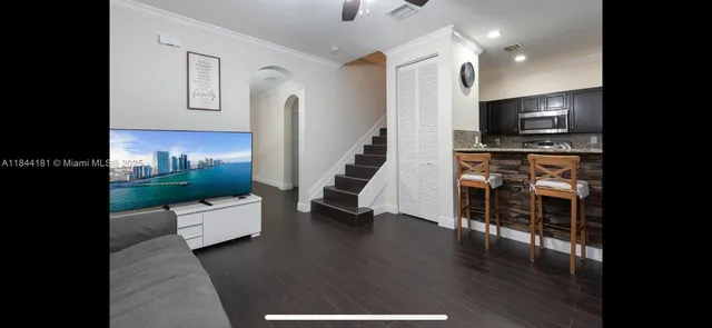 a living room with furniture and a flat screen tv