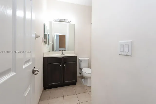 a bathroom with a sink a toilet and mirror
