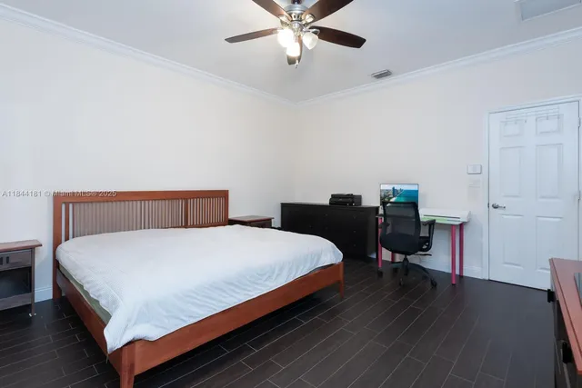 a bedroom with a bed and a desk