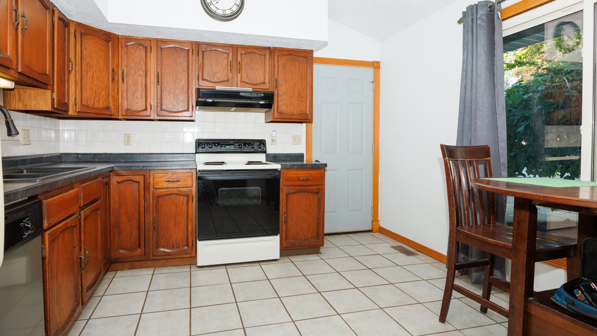 306 Judith Drive Normal, IL 61761 - Photo 12 of 40 a kitchen with a stove a refrigerator and wooden cabinets