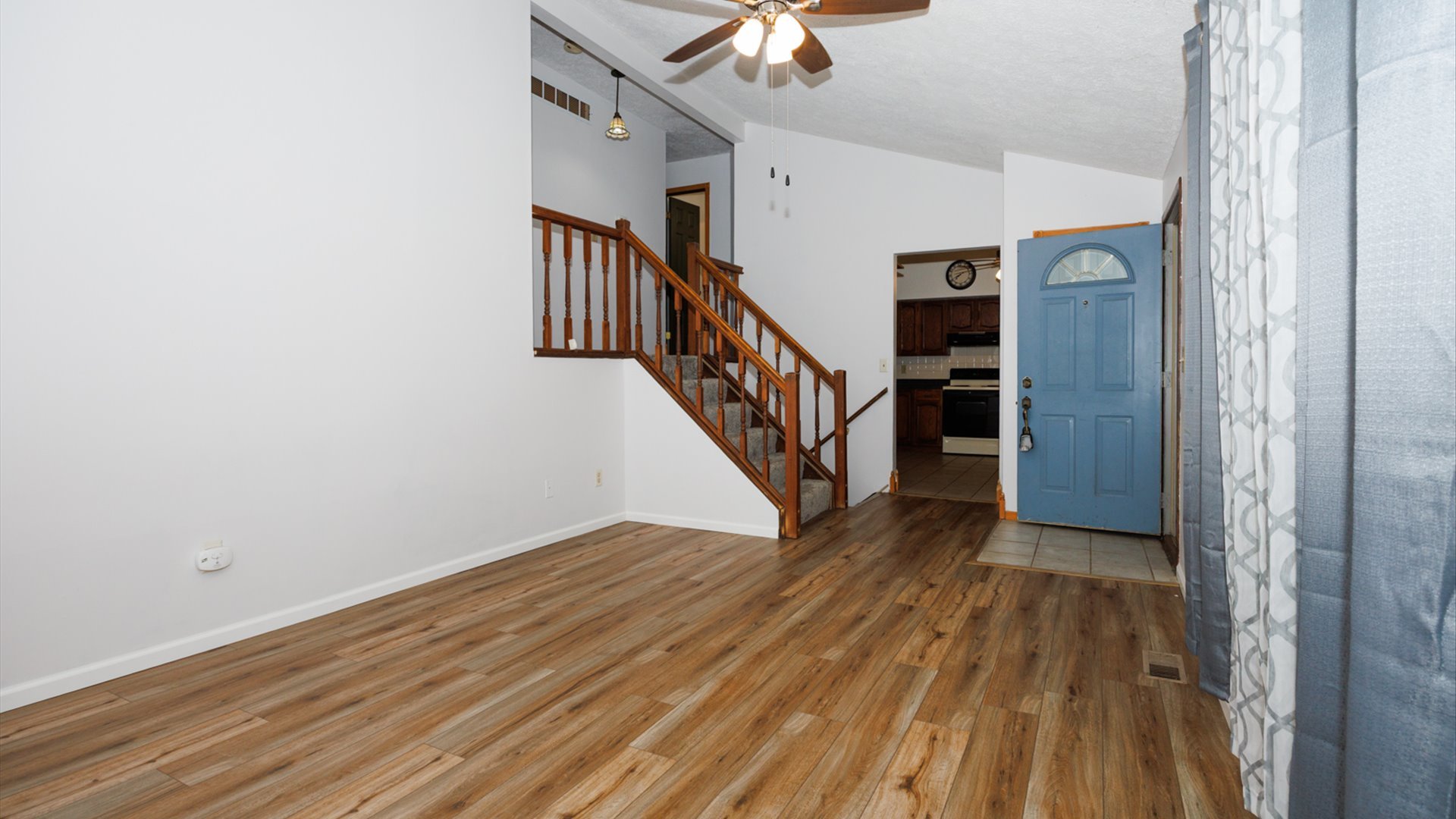 306 Judith Drive Normal, IL 61761 - Photo 10 of 40 a view of a hallway with wooden floor and staircase