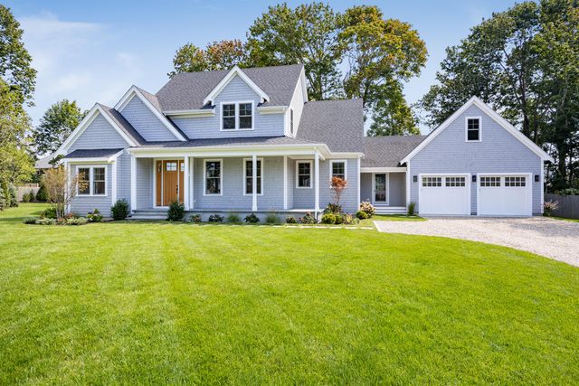 a front view of a house with swimming pool and porch