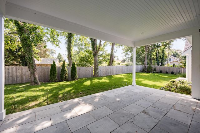 a view of backyard with large tree and plants