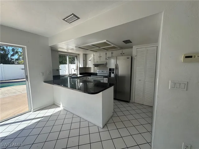 a kitchen with stainless steel appliances a refrigerator and a sink
