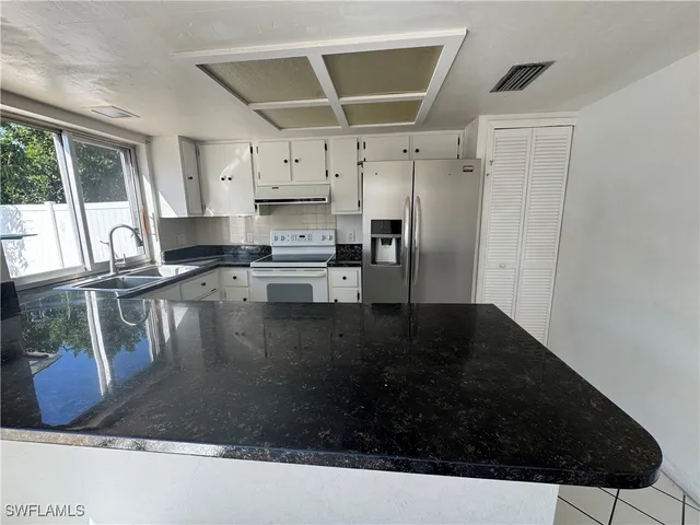 a kitchen with a sink and a stove