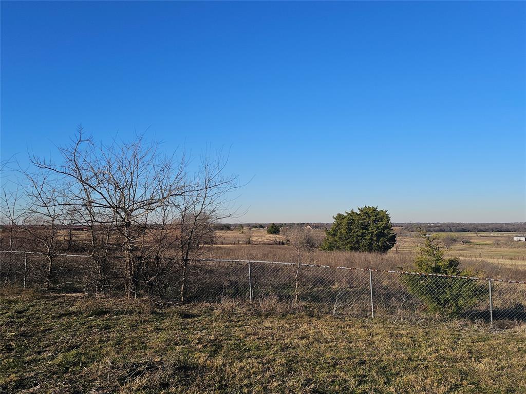810 Cody Road Ennis, TX 75119 - Photo 11 of 31 a view of a dry yard with wooden fence