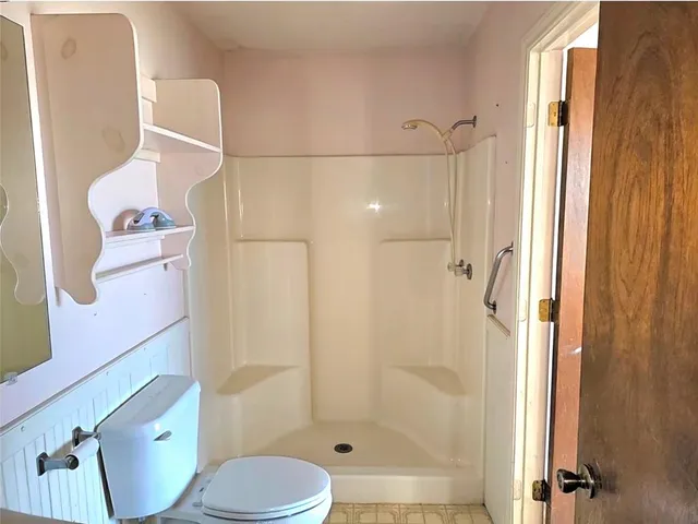 a bedroom with a bed and a ceiling fan