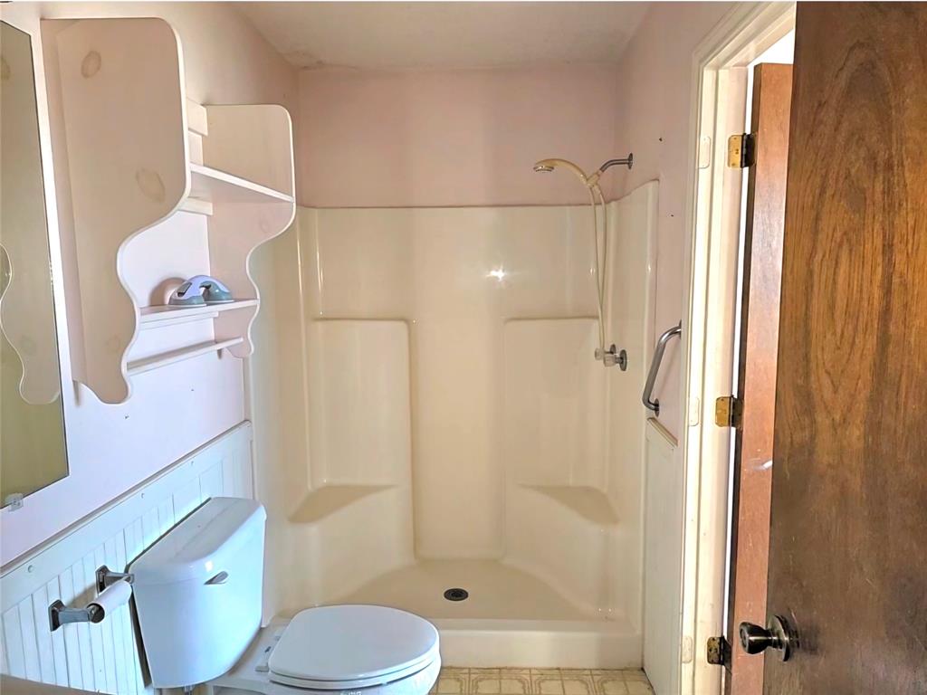 810 Cody Road Ennis, TX 75119 - Photo 20 of 31 a bathroom with a toilet and shower