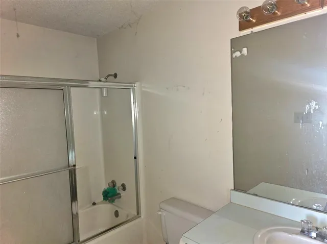 a large kitchen with stainless steel appliances a stove a sink a refrigerator and cabinets