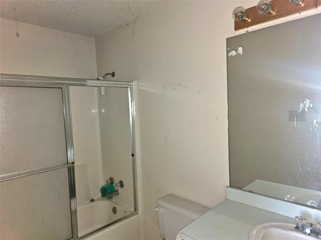 810 Cody Road Ennis, TX 75119 - Photo 22 of 31 a bathroom with a shower and toilet