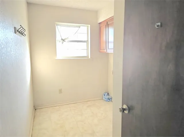 a view of room with window and wooden floor