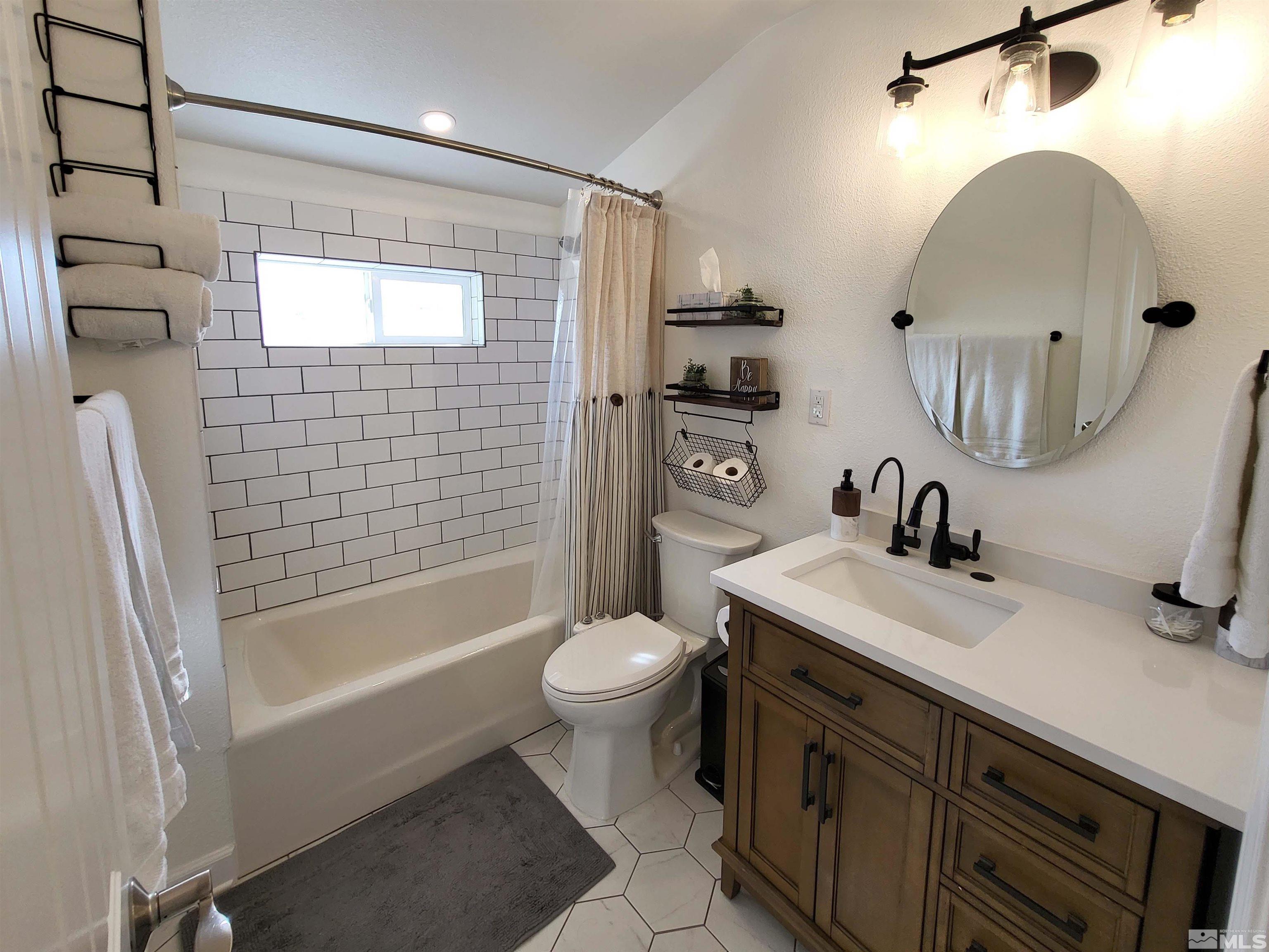 2700 Wilcox Ranch Road Reno, NV 89510 - Photo 26 of 33 a bathroom with a sink a toilet and shower