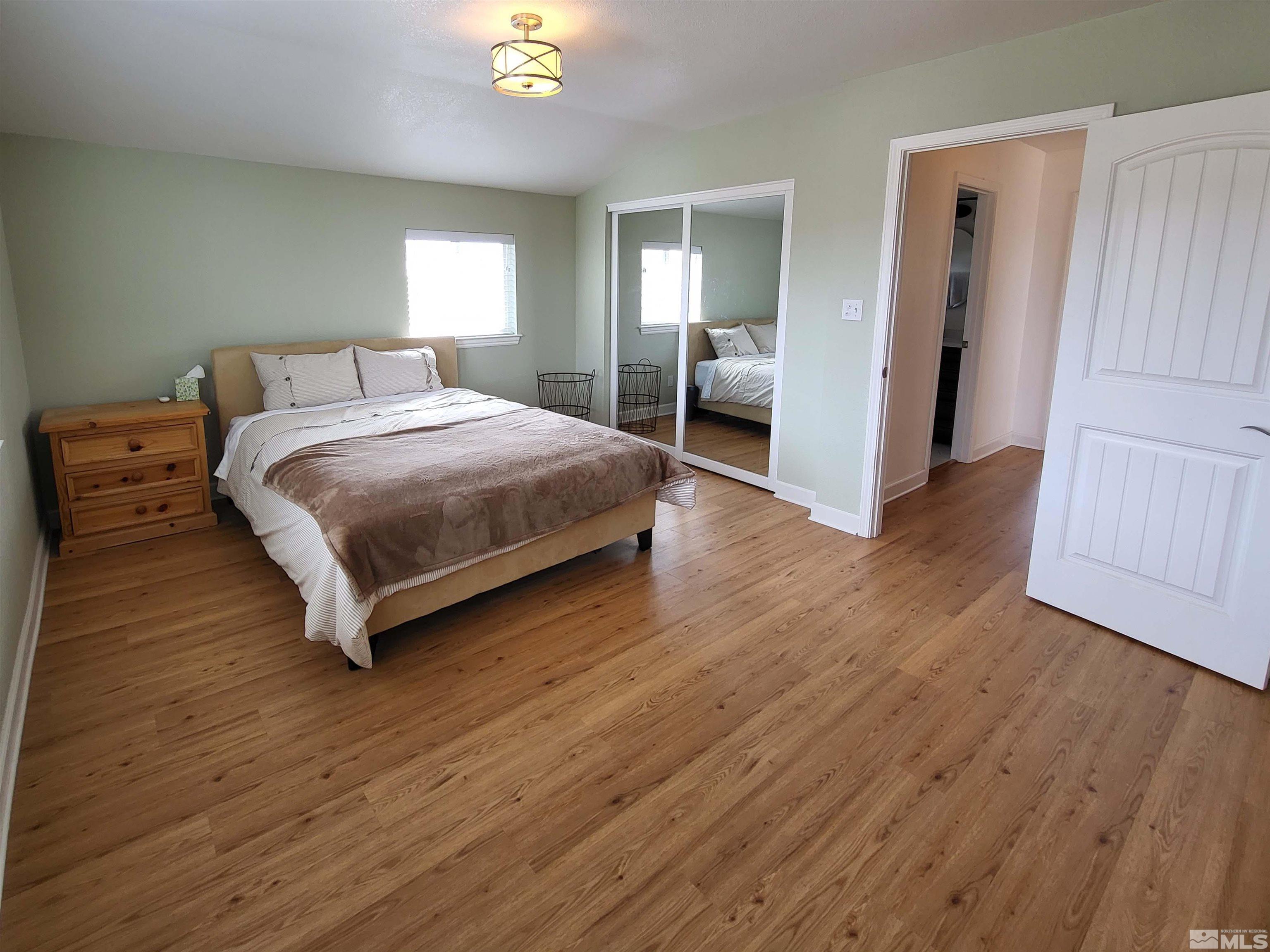 2700 Wilcox Ranch Road Reno, NV 89510 - Photo 28 of 33 a bedroom with a bed and wooden floor