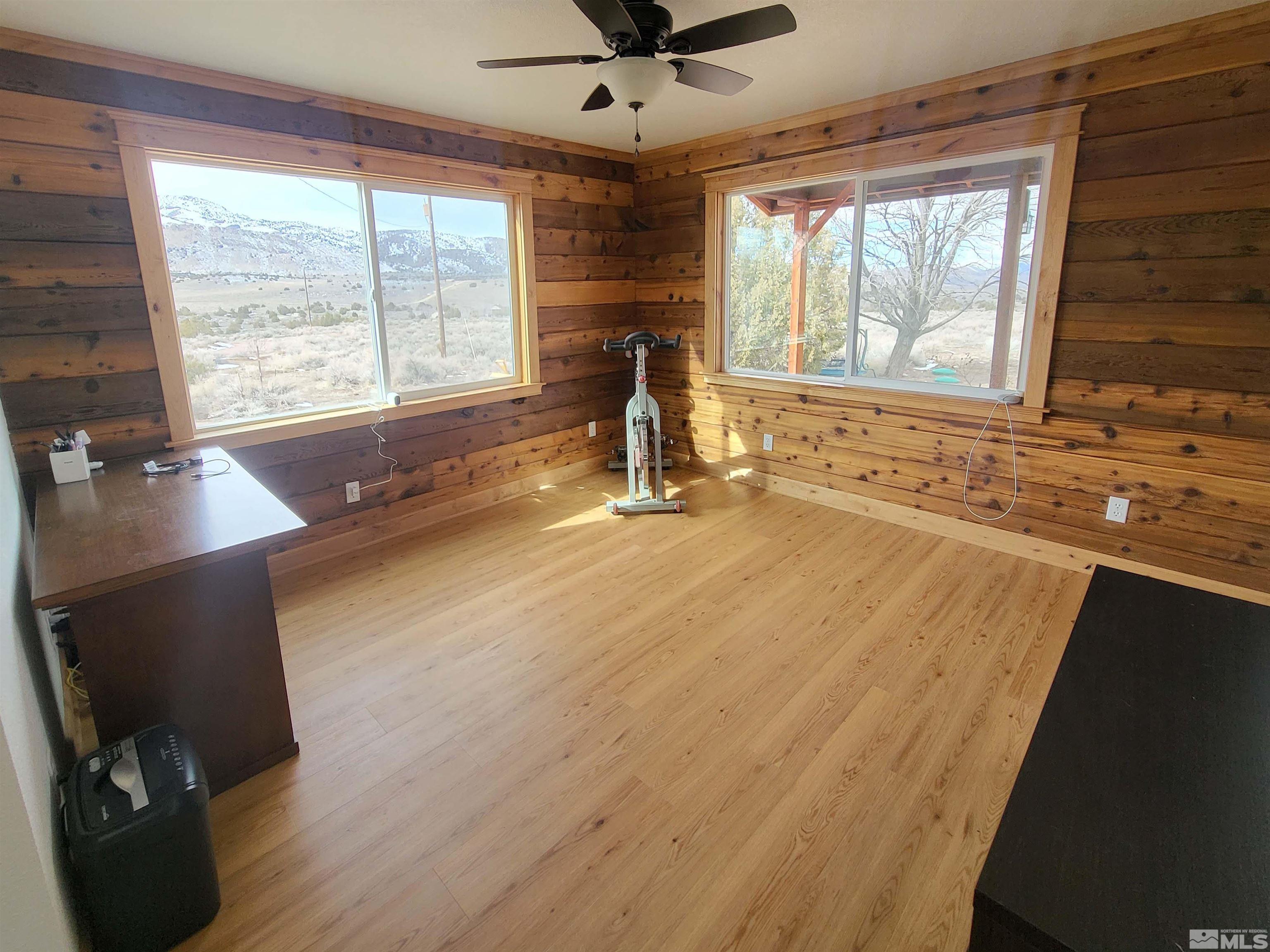 2700 Wilcox Ranch Road Reno, NV 89510 - Photo 5 of 33 a view of a room with wooden floor and a ceiling fan