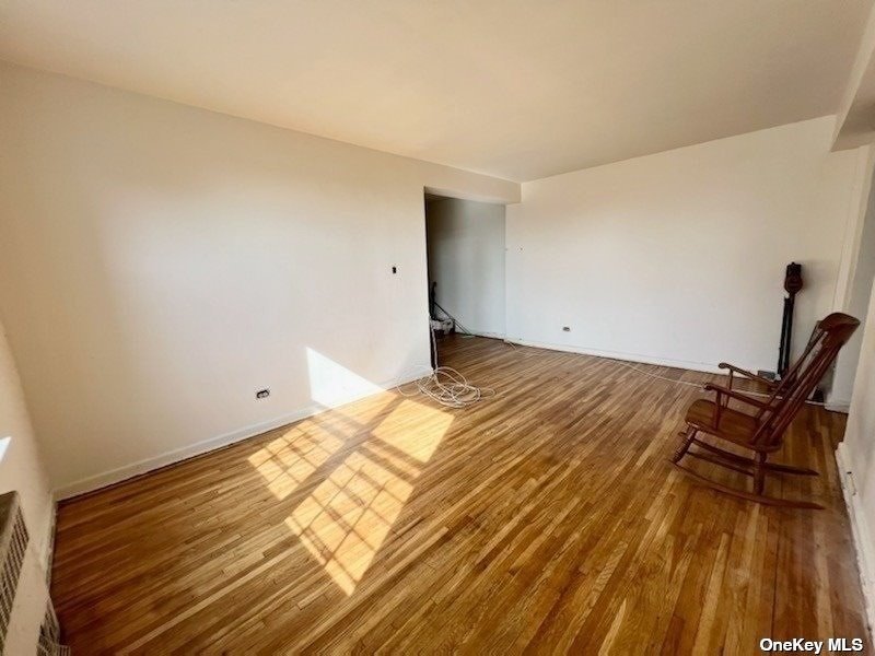 112-24 Northern Boulevard, Unit 4B Queens, NY 11368 - Photo 2 of 9 a view of a room with wooden floor and bench